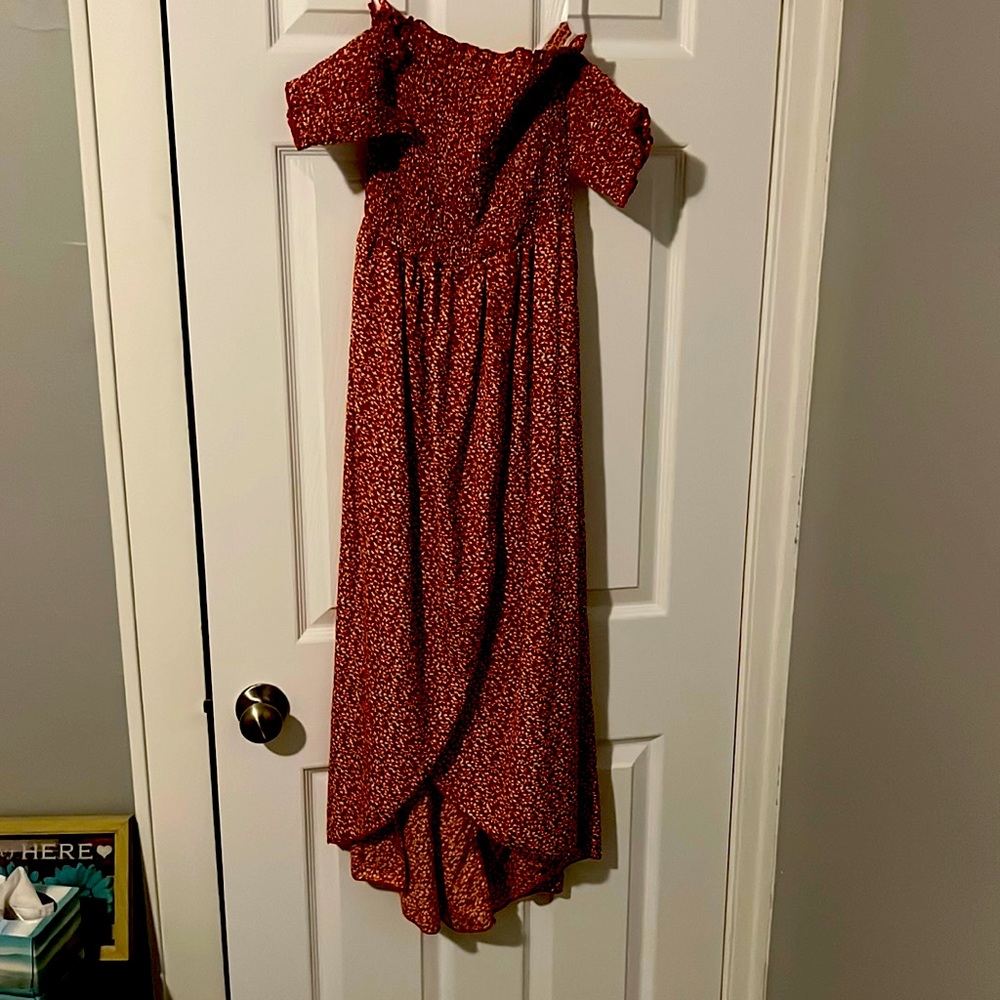 This is a dress that goes below the knees with a slit. It is red and cream.